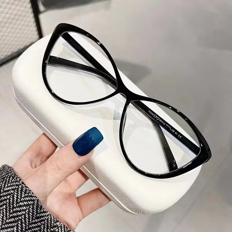 Front view of closed black cat eye glasses on white case