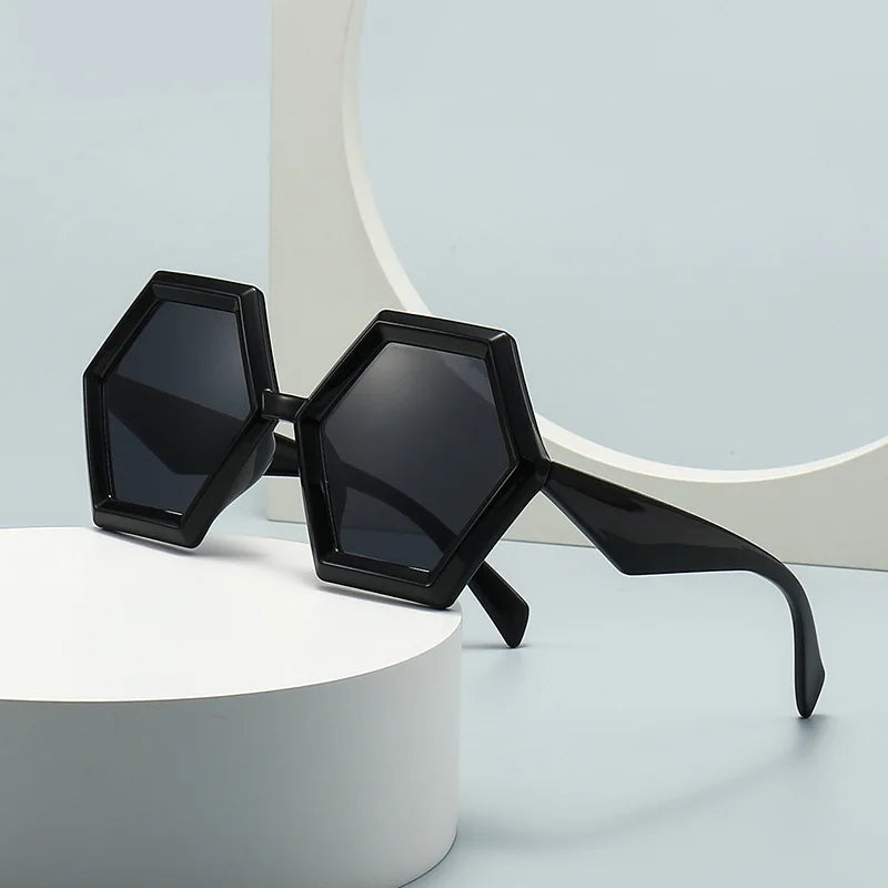 Black hexagon sunglasses displayed on minimal background