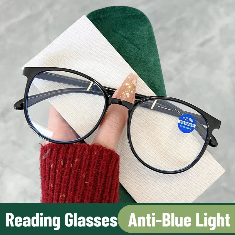 Close-up of black anti-blue light reading glasses held in hand