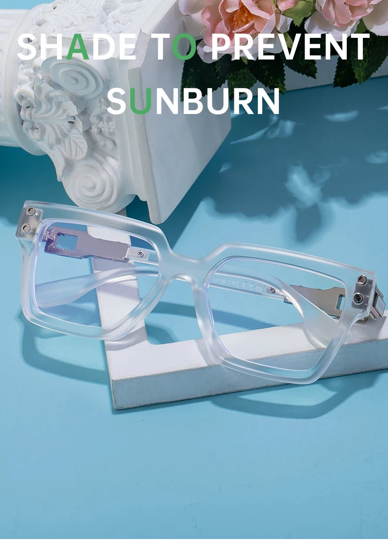 Crystal clear square sunglasses with silver accents on blue background