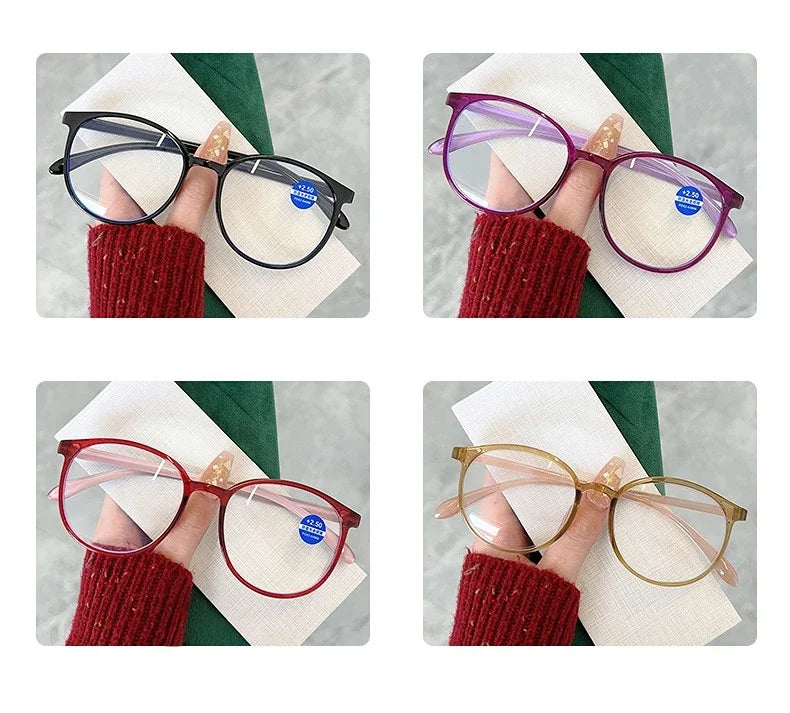 Reading glasses in four colors (black, purple, red, yellow) held by hand