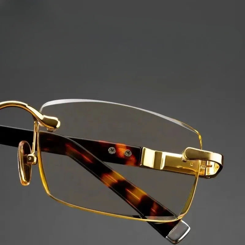 Side view of gold rimless glasses showing rectangular lens and designer hinge