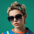 Model wearing retro square blue gradient sunglasses with bold frame and gradient lenses