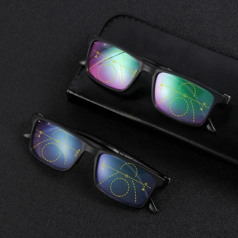 Two pairs of black progressive reading glasses on a black case