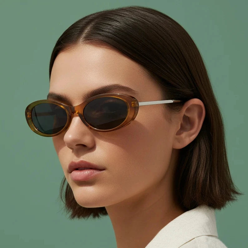 Woman wearing brown oval sunglasses with white arms