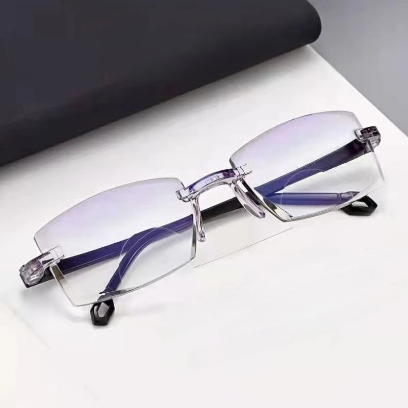 Angled view of rimless bifocal reading glasses on a white surface