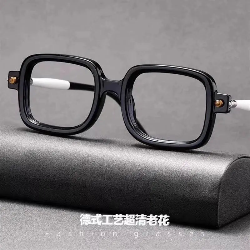 Square black reading glasses displayed on a case